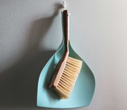 a broom and dustpan for cleaning your Panama City Beach storage unit